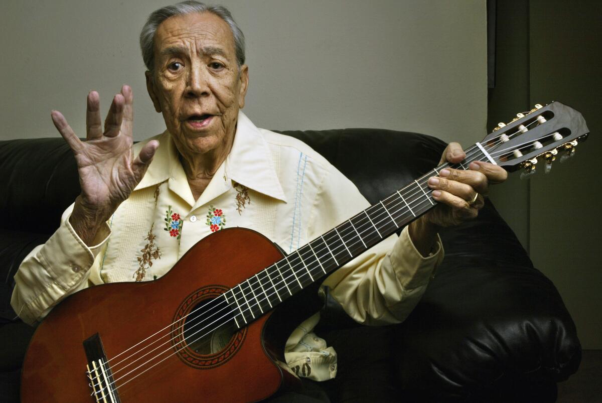 Lalo Guerrero, 87, plays his guitar.