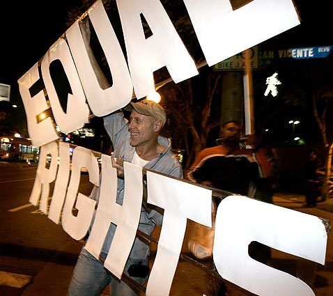 Marc Whittemore holds up a sign on Santa Monica Boulevard in West Hollywood during a protest against the passage of Proposition 8.