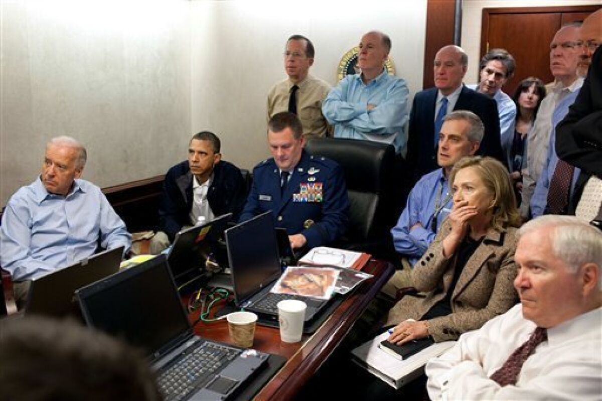 FILE - In this May 1, 2011 image released by the White House and digitally altered by the source to obscure the details of a document on the table, President Barack Obama, second from left, Vice President Joe Biden, left, Secretary of Defense Robert Gates, right, Secretary of State Hillary Rodham Clinton, second right, and members of the national security team watch an update on the mission against Osama bin Laden in the Situation Room of the White House in Washington. The killing of Osama bin Laden, first presented as a moment of national unity by the president, has become something else: a political weapon. Obama's re-election campaign is portraying his risky decision to go after America's top enemy as a defining difference with his Republican presidential opponent, suggesting Mitt Romney might not have had the guts to order a mission that put lives and perhaps a presidency at stake. (AP Photo/The White House, Pete Souza)