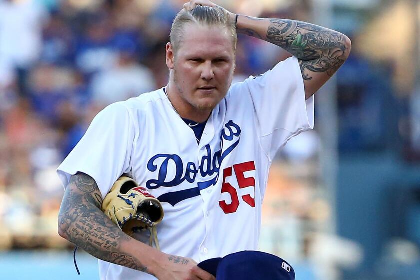 Dodgers starter Mat Latos gathers himself between batters during a game against the Chicago Cubs at Dodger Stadium on Aug. 29.