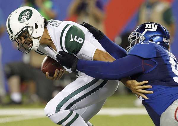 Jets' Sanchez is sacked by Giants' Austin
