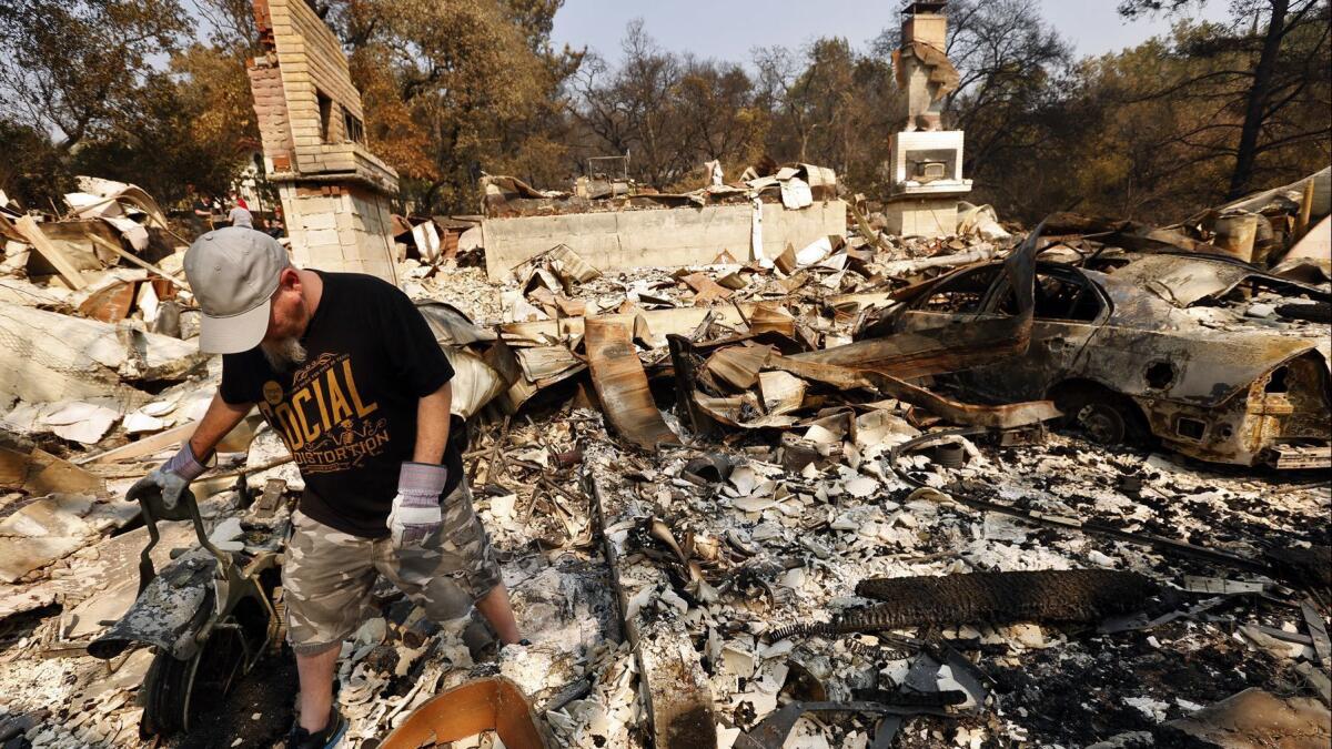 Phil Nelsen walks through the rubble of his grandfather's home that was destroyed in the Atlas fire in Napa on Oct. 13.