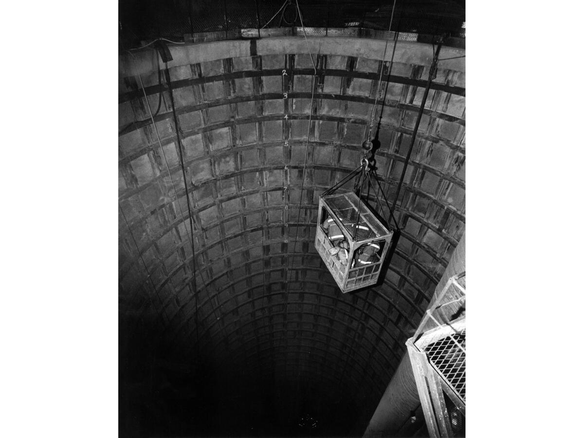 June 24, 2971: Firemen are lowered into Gate Shaft during attempts to rescue miners who were drilling a Metropolitan Water District tunnel in Sylmar.