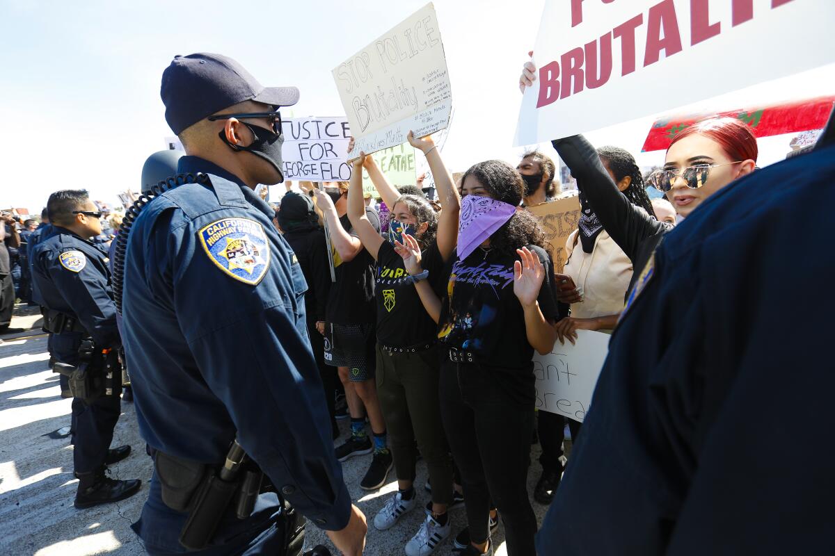 Protesters calling for justice for George Floyd are temporarily blocked by CHP officers from accessing anonramp to Interstate 8. 