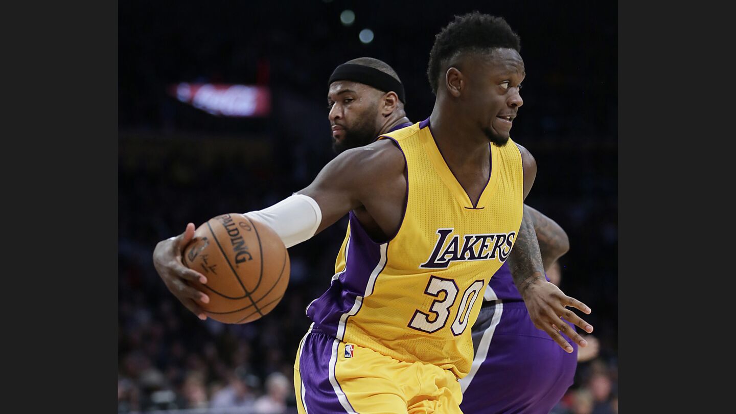 Lakers forward Julius Randle drives past Kings forward DeMarcus Cousins during the first half of a game at Staples Center on Feb. 14.