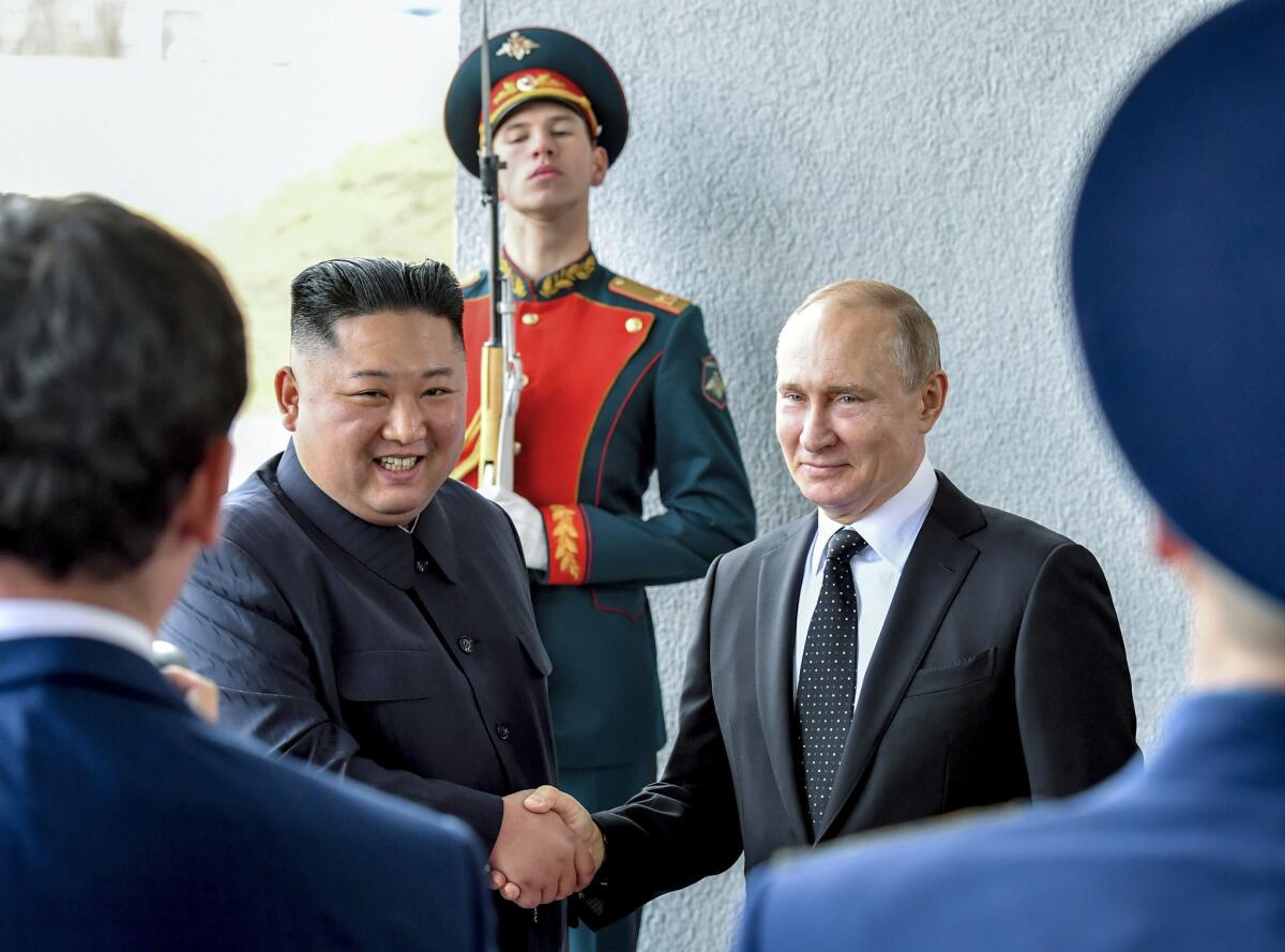 Russian President Vladimir Putin and North Korea's leader Kim Jong Un shake hands during their meeting in Vladivostok, Russia, on Thursday. Putin and Kim are set to have a one-on-one meeting at the Far Eastern State University.