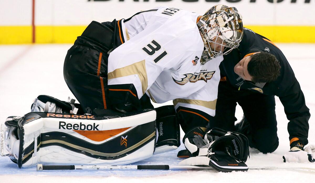Ducks trainer Joe Huff talks with injured goalie Frederik Andersen in the third period of Game 3 against the Kings on Thursday night at Staples Center.