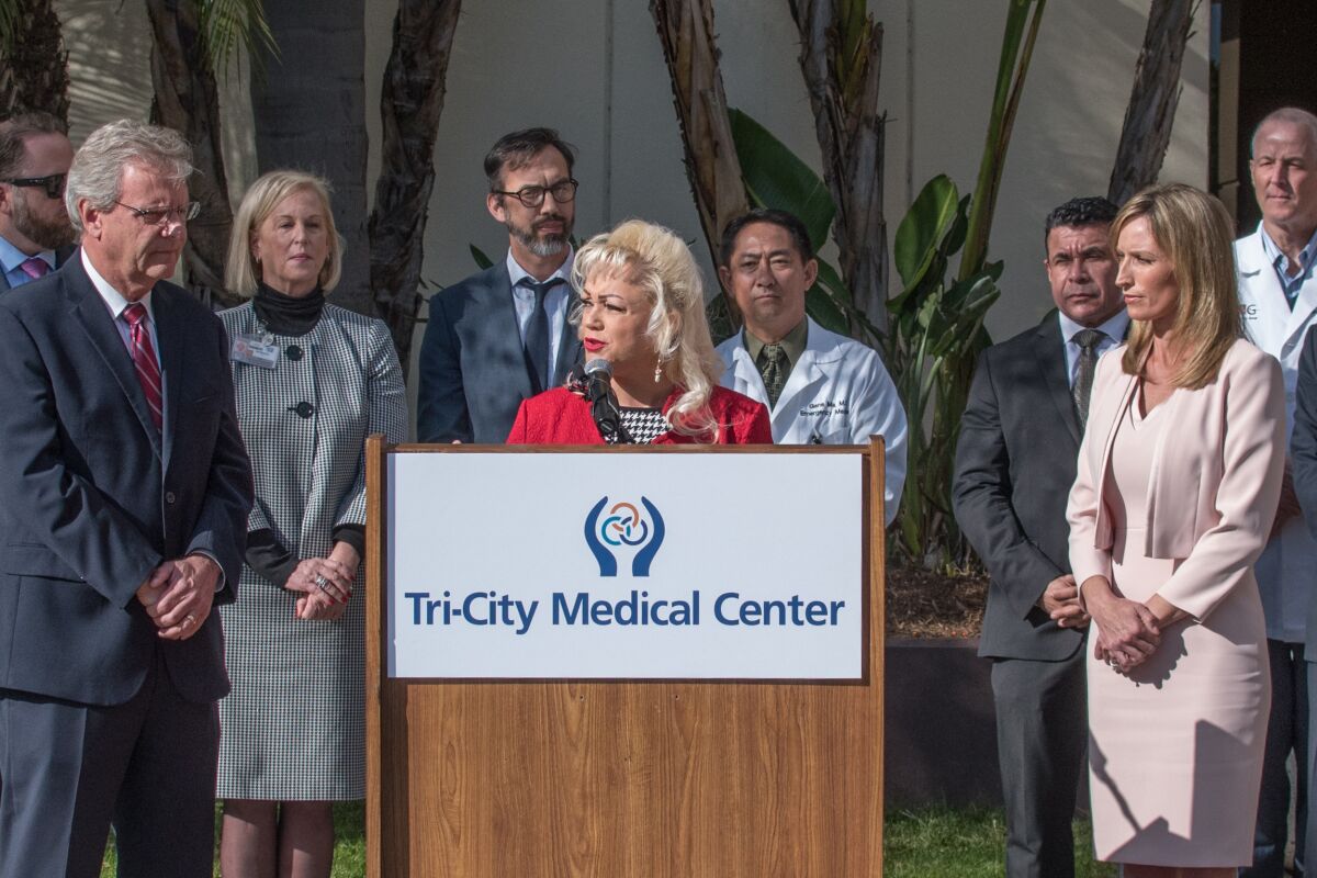 Tri-City Medical Center board chair Leigh Anne Grass announces a joint agreement Monday morning that, if fully approved, will build a 16-bed $17 million behavioral health unit at the Oceanside hospital within two to three years. Grass is surrounded by county and hospital officials including county supervisors Jim Desmond (far left) and Kristin Gaspar (far right).