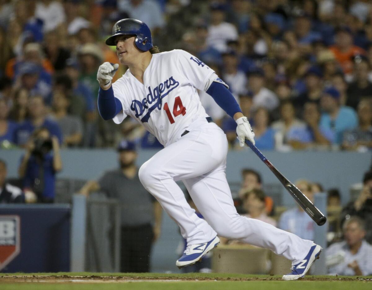 The Dodgers' Enrique Hernandez hits a single against the New York Mets on Oct. 10.