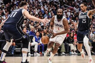 Clippers guard James Harden loses control of the ball as he drives past Mavericks guard Luka Doncic 