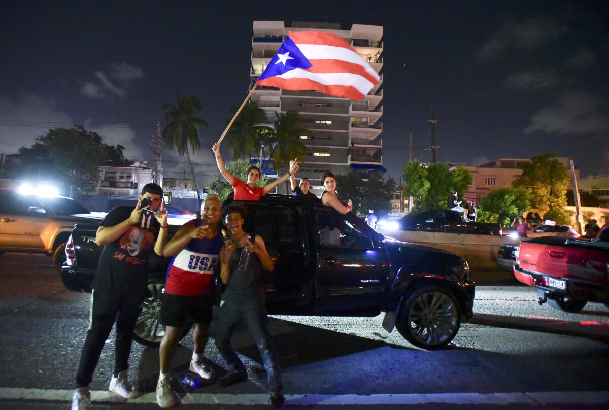 Puerto Ricans celebrate after Gov. Ricardo Rossello's announcement.