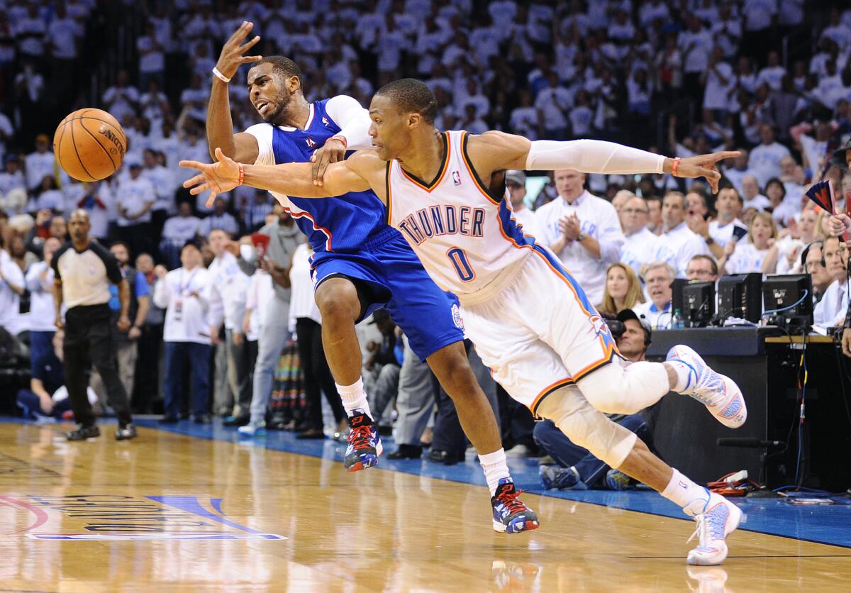 Thunder point guard Russell Westbrook steals the ball from Clippers point guard Chris Paul late in the fourth quarter in Game 5 of the playoffs last season.
