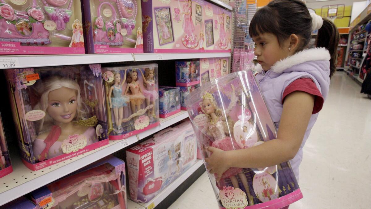 Yvette Ibarra holds a Dancing Princess Barbie doll while shopping at a Toys R Us in Monrovia, Calif., in 2007.