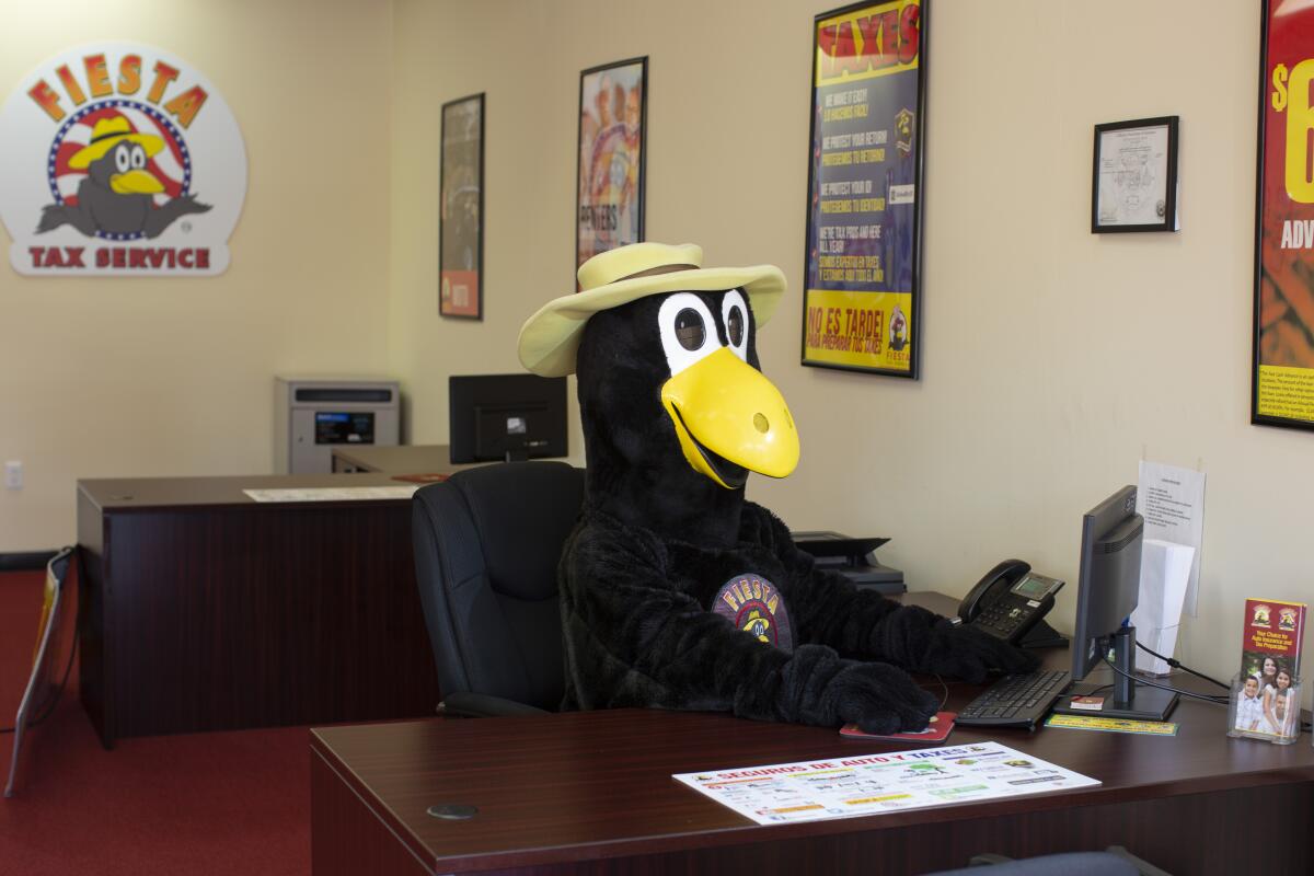 Elias Ortiz, dressed as Max the Magpie, inside Fiesta Auto Insurance in East L.A.