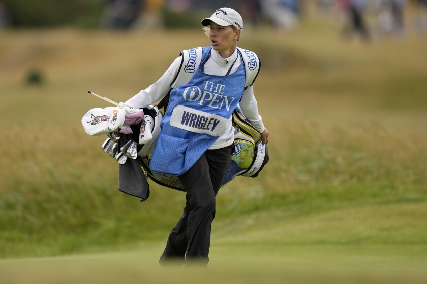 Joanna Gustavsson carries her husband Alex Wrigley's clubs at the British Open.
