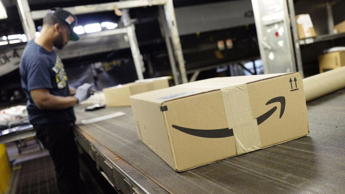 A package from Amazon moves on a conveyor belt at a UPS facility May 9, 2017, in New York.