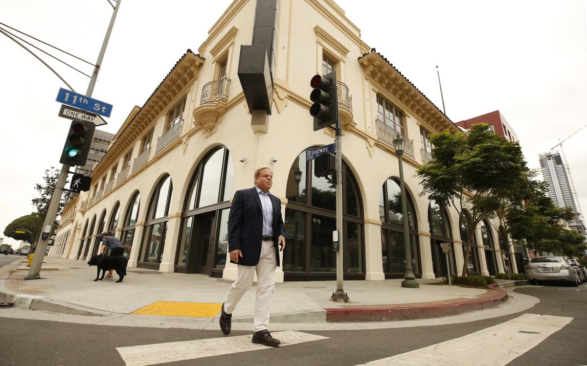 Michael Fischer walks outside the Herald Examiner Building in downtown Los Angeles.