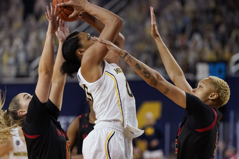 Michigan forward Naz Hillmon (00) attempts a shot as Maryland guard Faith Masonius, left, and forward Alaysia Styles defend during the first half of an NCAA college basketball game, Thursday, March 4, 2021, in Ann Arbor, Mich. (AP Photo/Carlos Osorio)