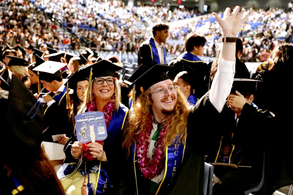Faith Couts, 50, left, and son Hunter Wetzel, 22, both of Rancho Santa Margarita, graduate together during a ceremony 