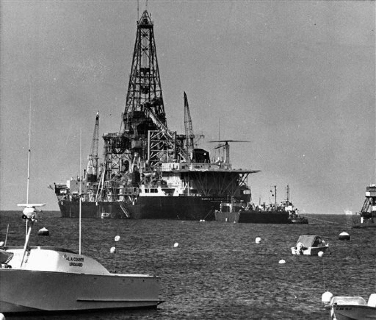 FILE - In this May 8, 1975, file photo boaters watch the arrival of the Hughes Glomar Explorer off Catalina Island, Calif. In August 1974 the ship fished a sunken Soviet nuclear-armed submarine out of the Pacific Ocean depths, took what it could of the wreck, and made off to Hawaii with its purloined prize. Over 30 years later the CIA is finally shedding light on the extraordinary Cold War spy mission, Project Azorian, but minus the juicy details. (AP Photo, File)