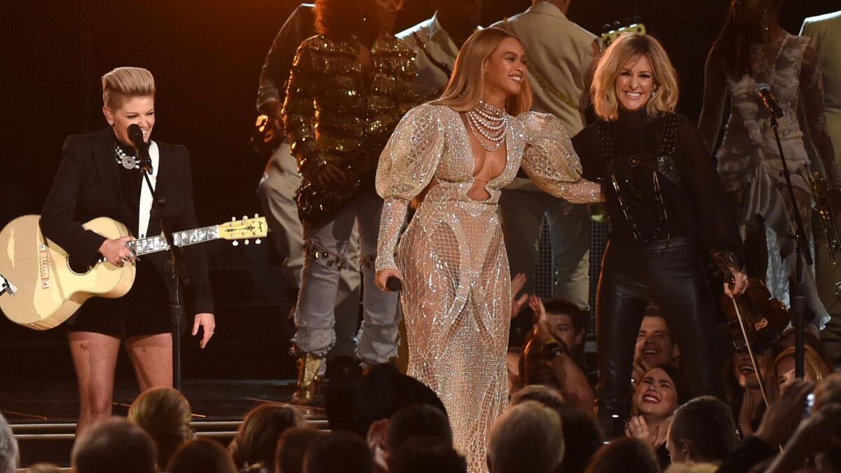 Beyoncé performs onstage with Martie Maguire of the Dixie Chicks at the 50th annual CMA Awards.