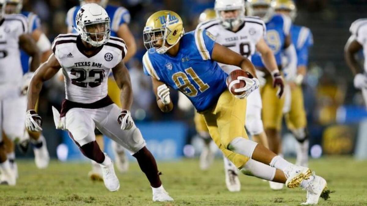 UCLA tight end Caleb Wilson runs with the ball while Texas A&M's Armani Watts defends Sept. 3. Wilson made a school-record 15 catches in the game.