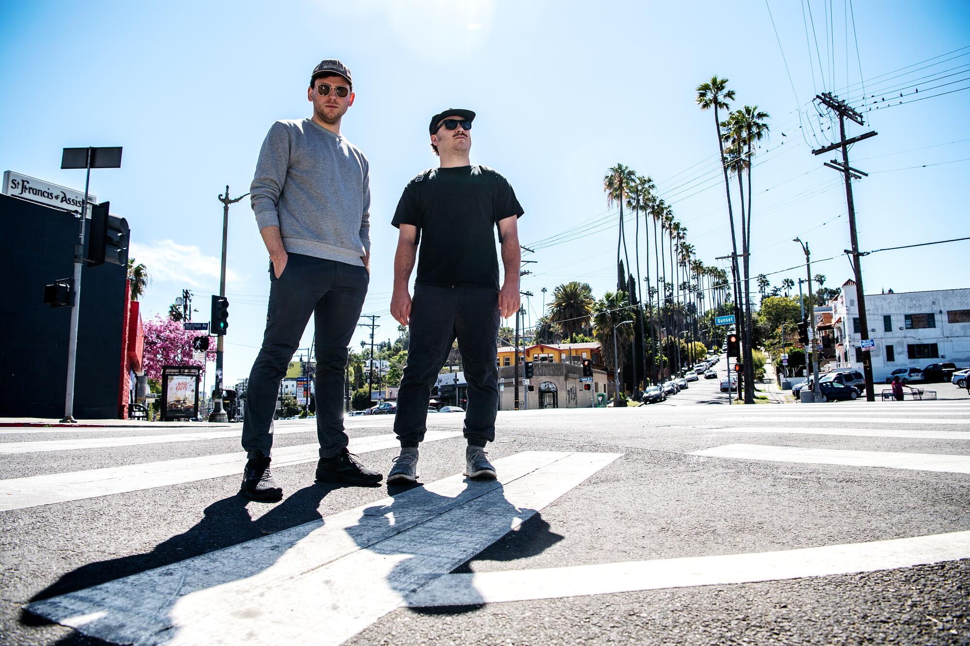 Brooke Palmieri and Zachary Weathers stand in a crosswalk on Sunset Boulevard.