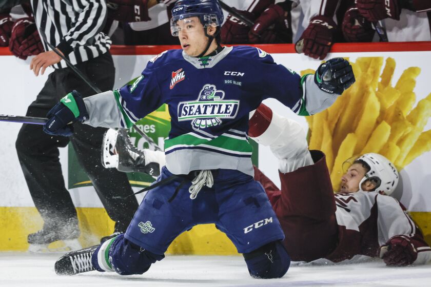 Seattle Thunderbirds defenseman Jeremy Hanzel, front, looks around after checking Peterborough Petes forward Brennan Othmann during the second period of a CHL Memorial Cup hockey semifinal Friday, June 2, 2023, in Kamloops, British Columbia. (Jeff McIntosh/The Canadian Press via AP)