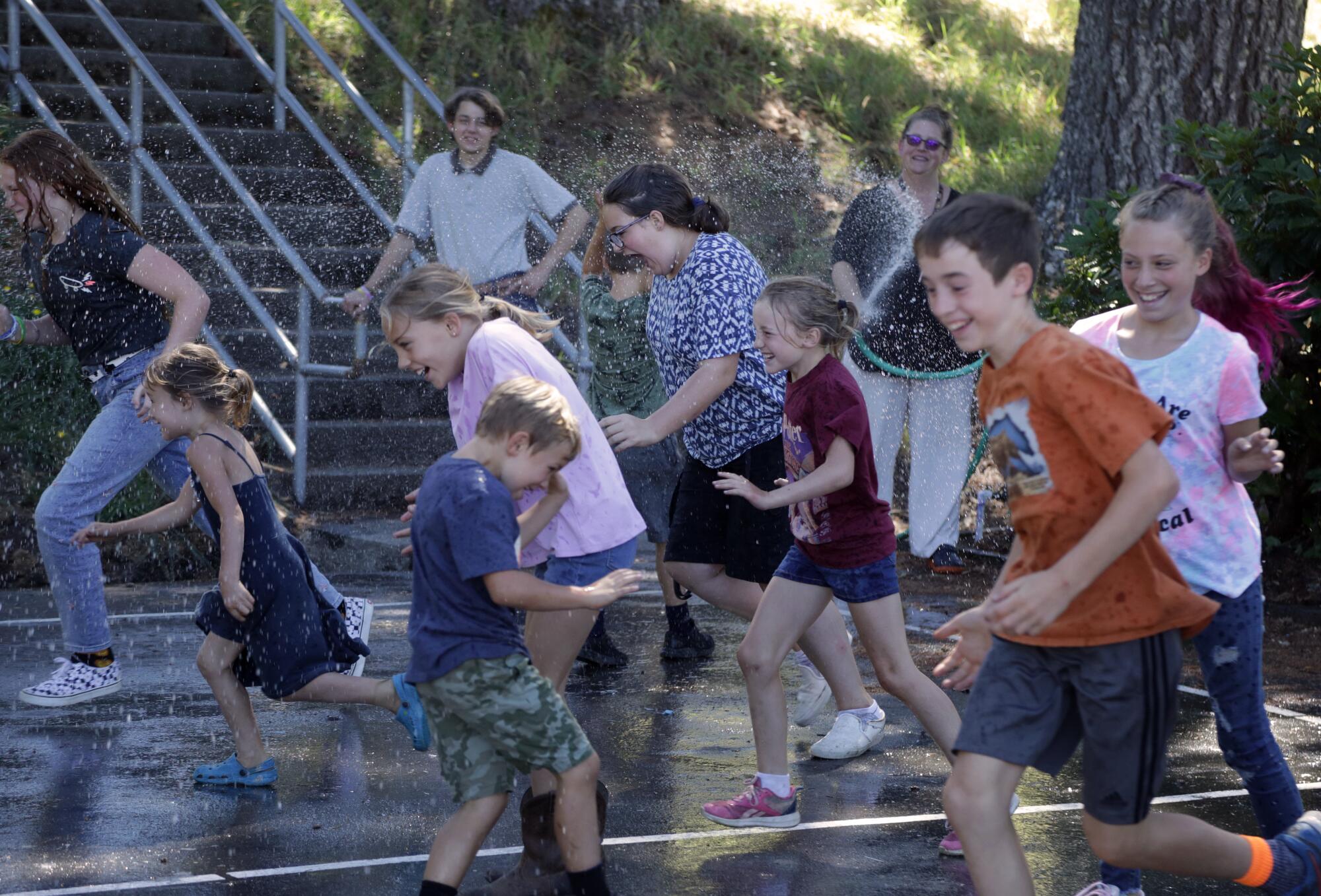 Kneeland Elementary schoolchildren play outside.