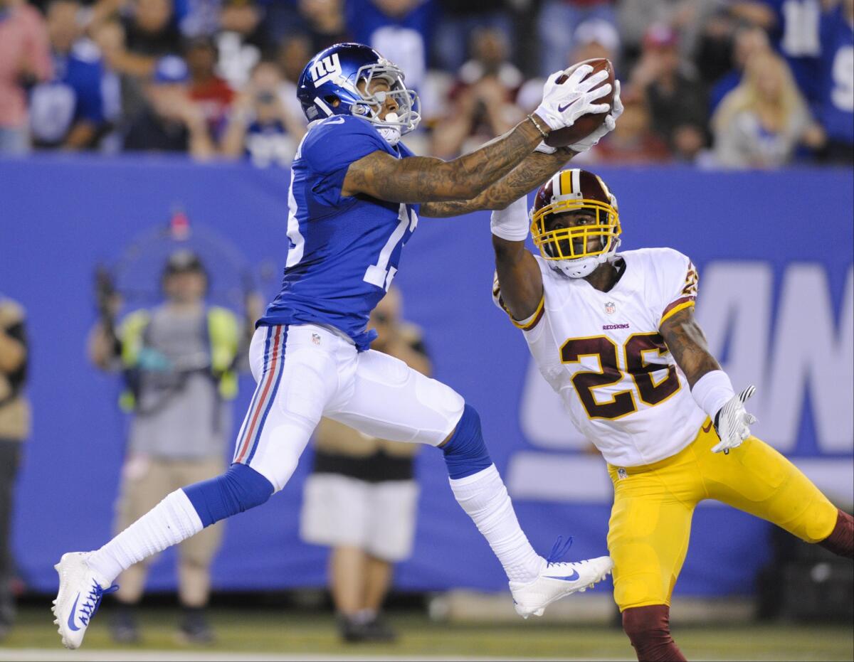 New York Giants receiver Odell Beckham catches a pass for a touchdown in front of Redskins cornerback Bashaud Breeland (26) during the second half a game on Sept. 24.