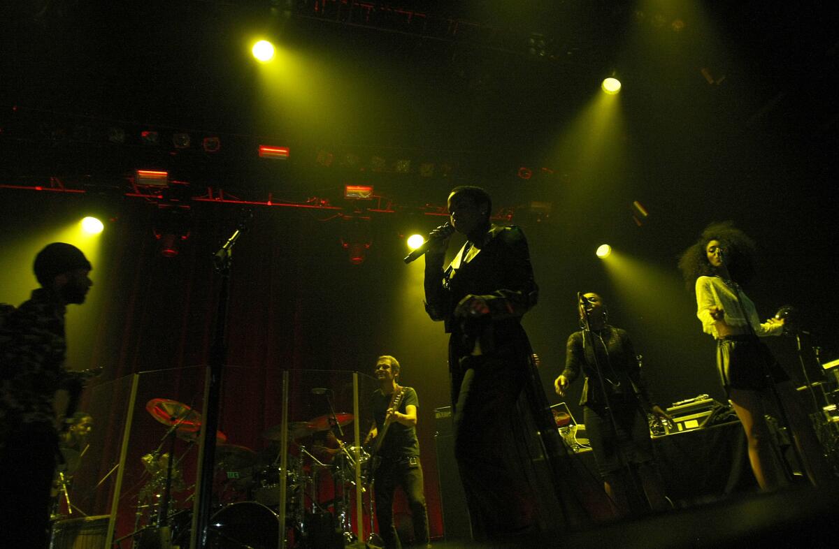 Soul singer Lauryn Hill, center, takes the stage at Club Nokia in Los Angeles on Saturday, May 18, 2014. She has cancelled a tour date in Tel Aviv after a show in Palestine fell through.