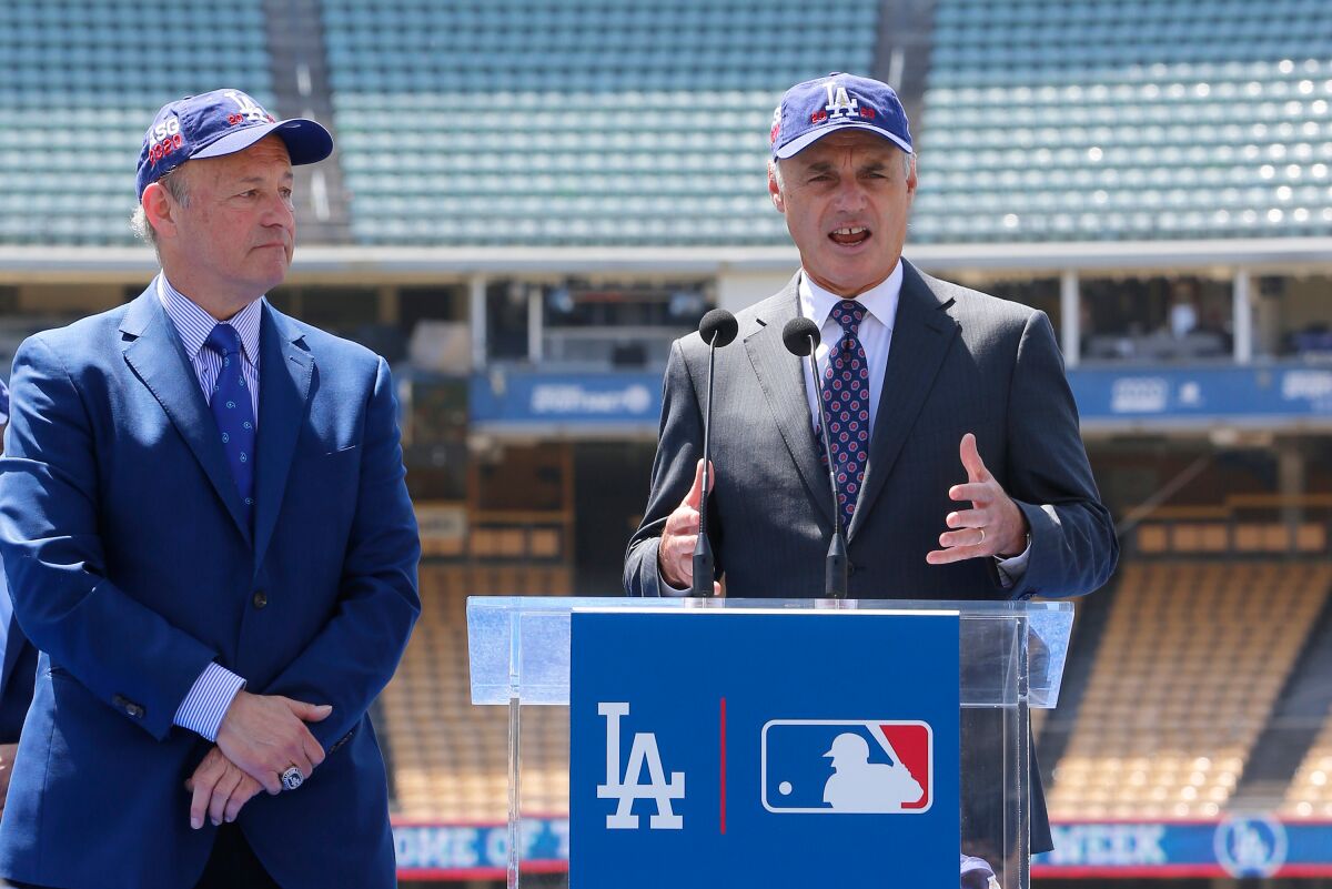 MLB commissioner Rob Manfred speaks next to Stan Kasten during a news conference at Dodger Stadium.