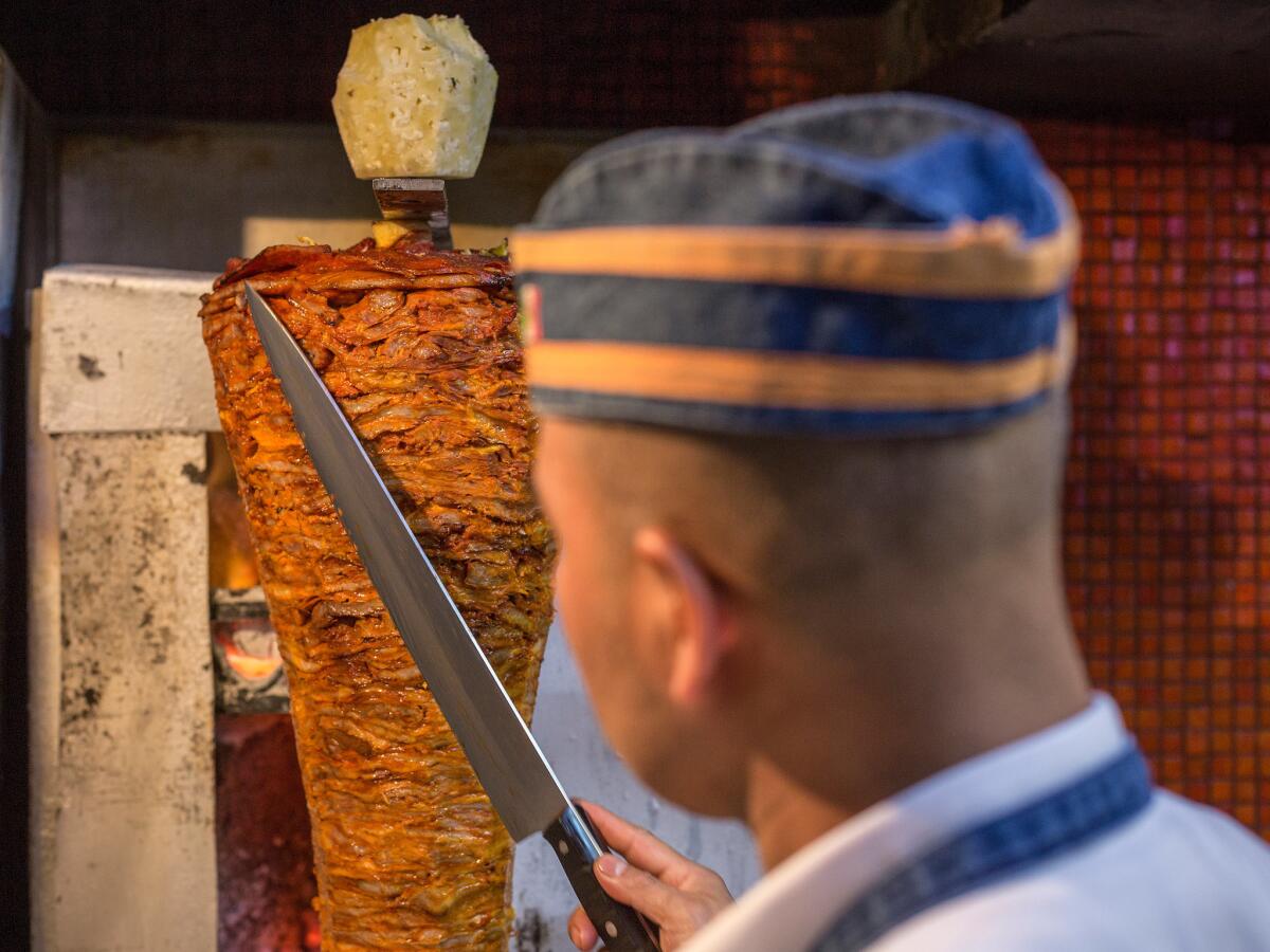 Preparation of an al pastor taco at El Tizoncito.