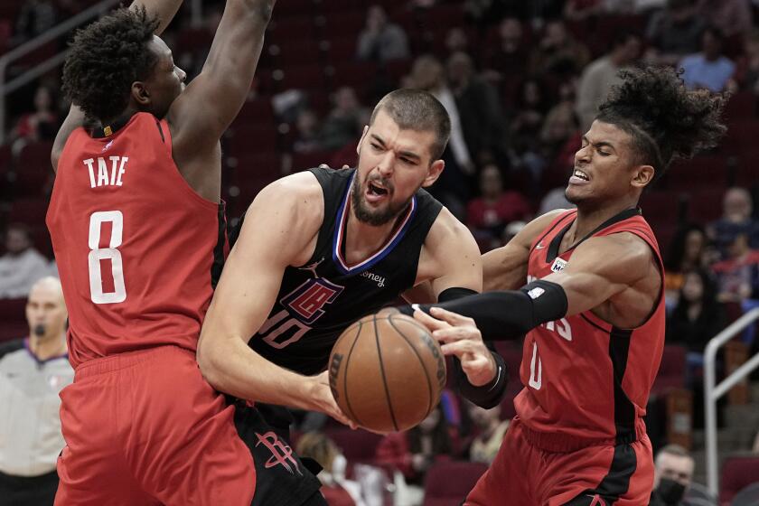 Los Angeles Clippers' Ivica Zubac (40) is fouled by Houston Rockets' Jalen Green (0) as Jae'Sean Tate (8) helps defend during the second half of an NBA basketball game Tuesday, March 1, 2022, in Houston. The Clippers won 113-100.(AP Photo/David J. Phillip)