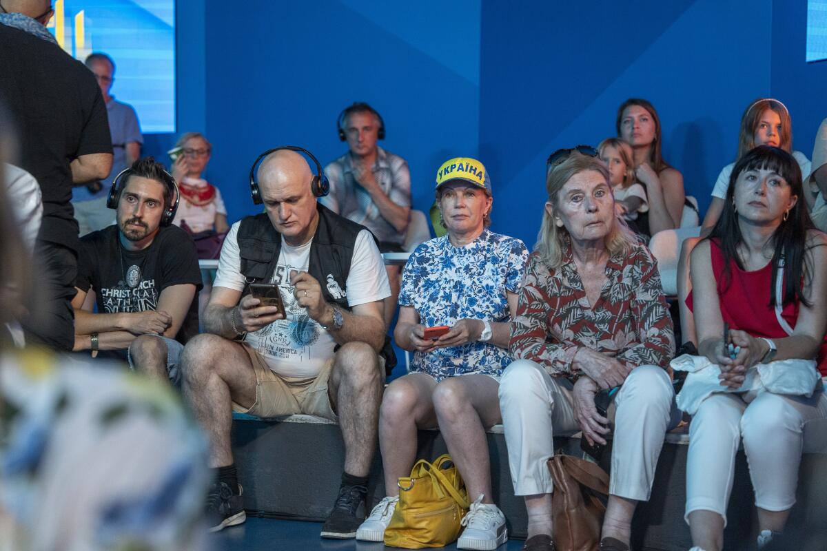 People attend a public talk at the Ukrainian House in Paris.