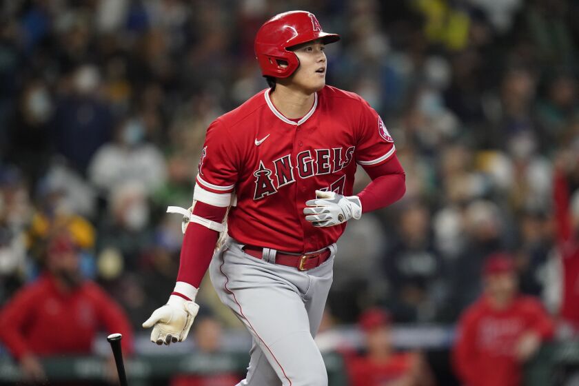 Los Angeles Angels' Shohei Ohtani watch the path of his solo home run against the Seattle Mariners in the first inning of a baseball game Sunday, Oct. 3, 2021, in Seattle. (AP Photo/Elaine Thompson)