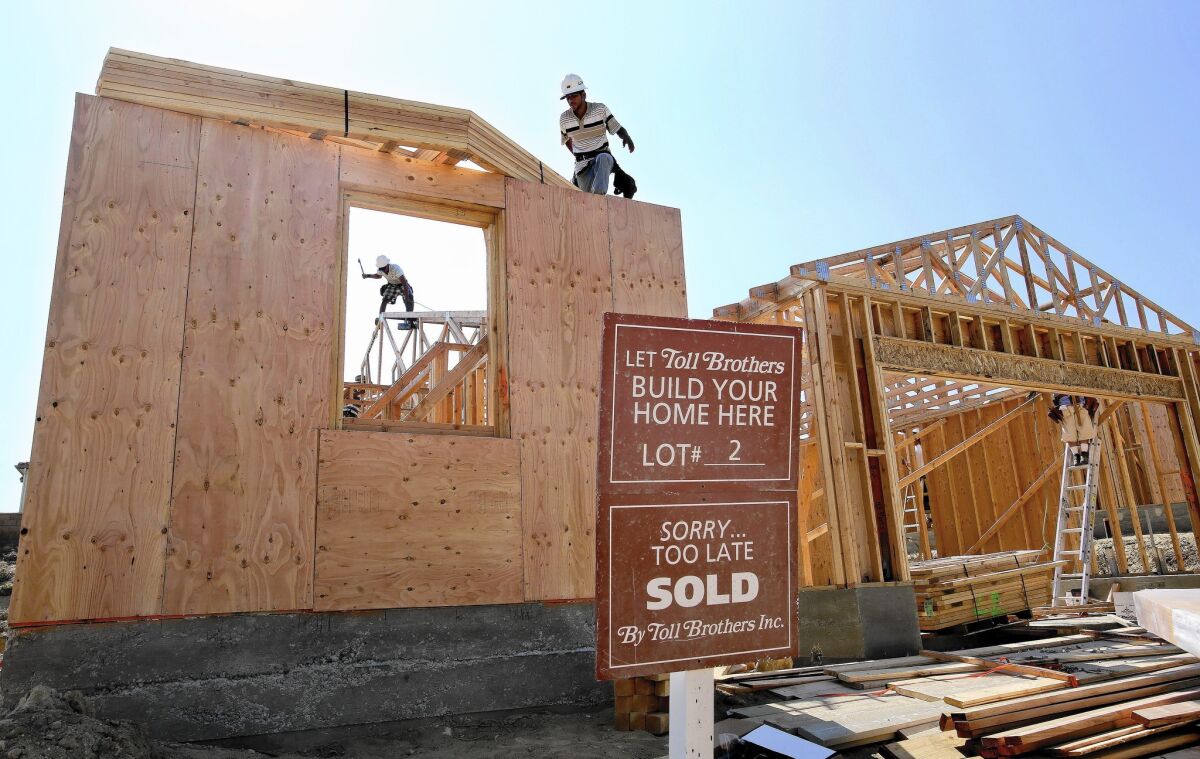 The average rate for a 30-year fixed mortgage fell this week to an 18-month low, Freddie Mac says. Above, luxury homes under construction in October in Porter Ranch.