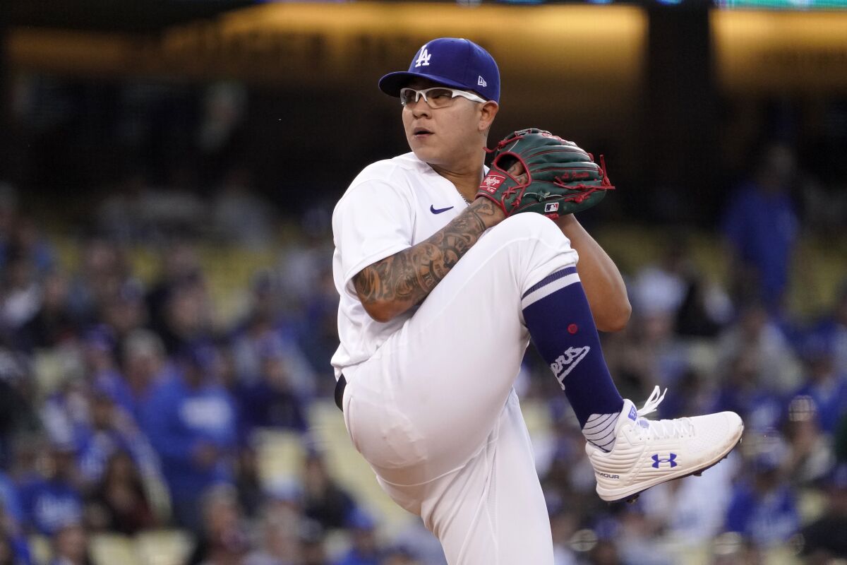Dodgers starting pitcher Julio Urías prepares to throw to the plate against the Giants 