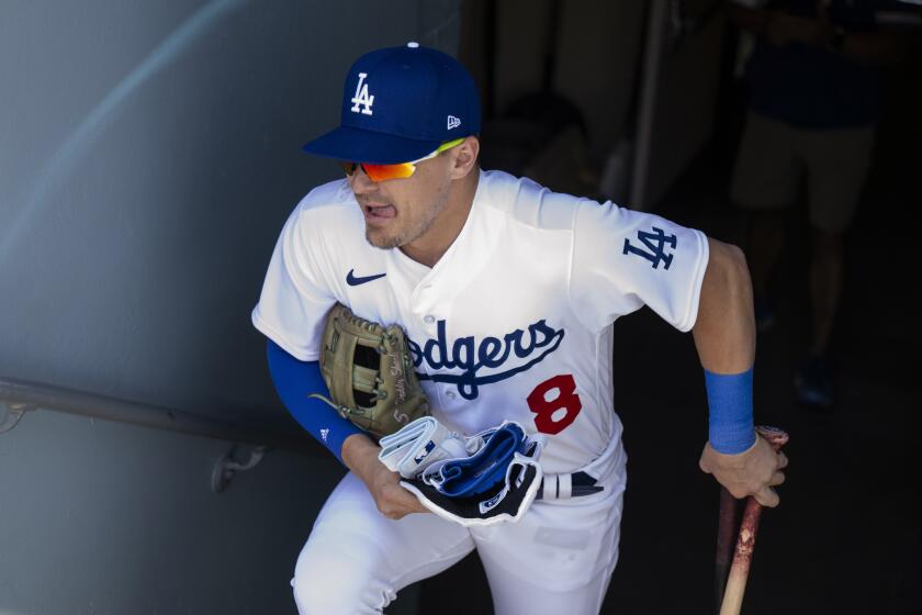 Los Angeles Dodgers' Kiké Hernández enters the dugout before the team's baseball game against the Toronto Blue Jays in Los Angeles, Wednesday, July 26, 2023. (AP Photo/Kyusung Gong)