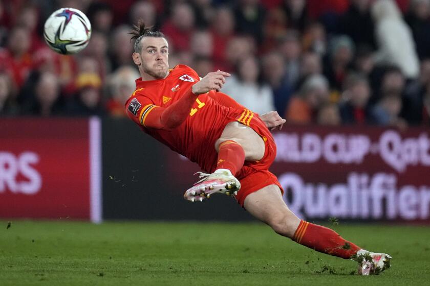 FILE - Wales' Gareth Bale takes a shot during the World Cup 2022 playoff soccer match between Wales and Austria.