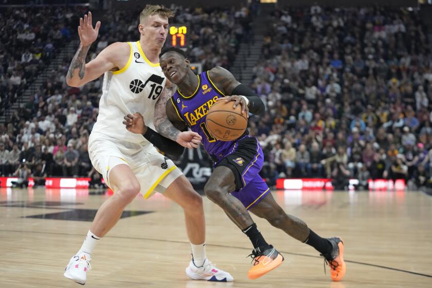 Los Angeles Lakers guard Dennis Schroder, right, drives against Utah Jazz forward Luka Samanic (19) during the first half of an NBA basketball game Tuesday, April 4, 2023, in Salt Lake City. (AP Photo/Rick Bowmer)