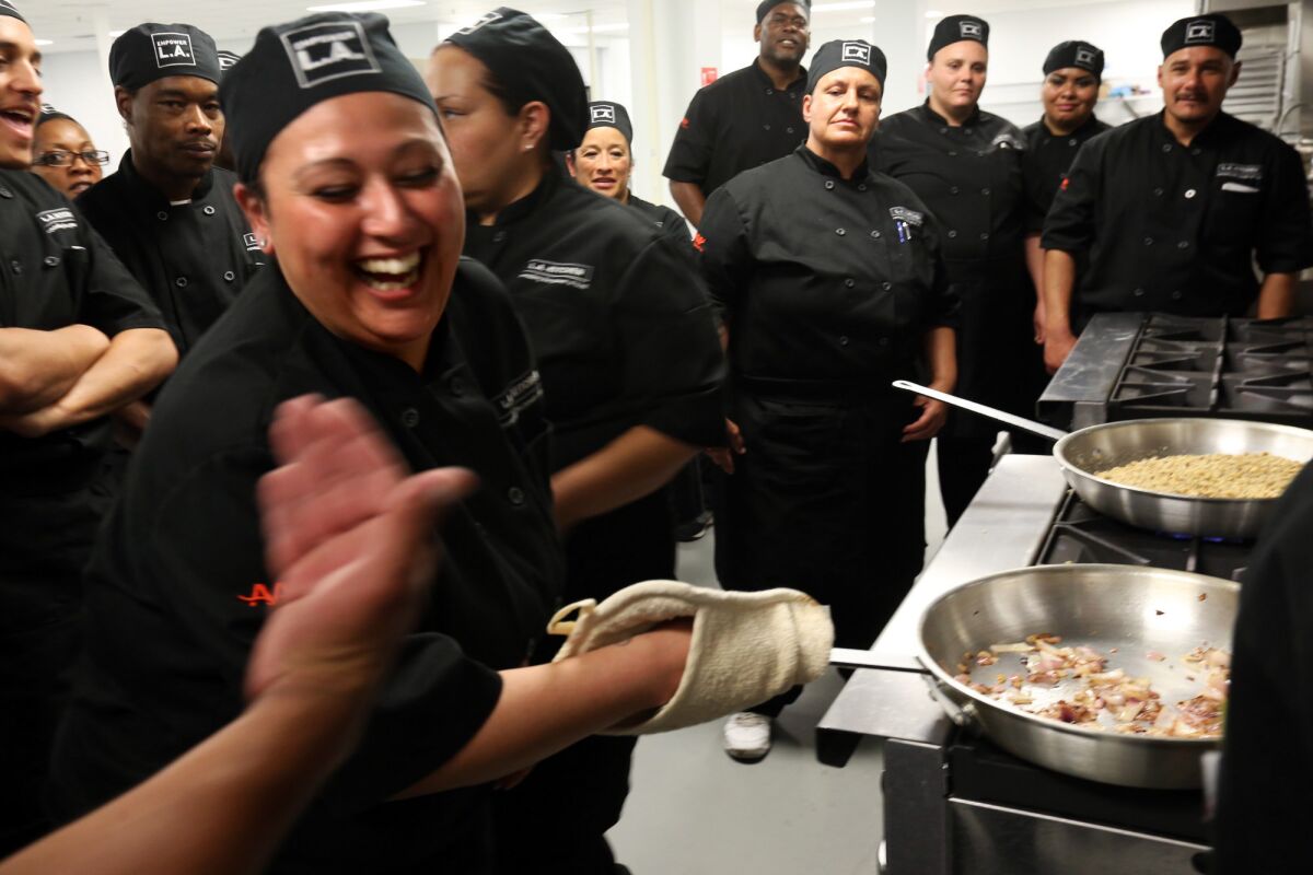 L.A. Kitchen's Raquel Sendejas learns to flip onions during a class.