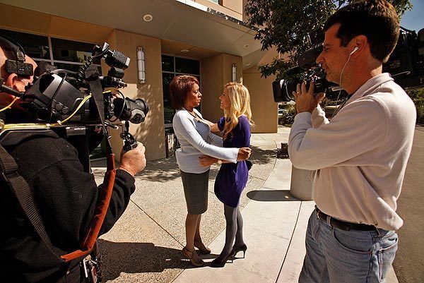 KCBS-TV reporter Serene Branson, right, is greeted at the studio's front door by KCBS news anchor Pat Harvey. Branson received national attention when she began speaking incoherently during a live report from the Grammy Awards. Doctors say she suffered from "migraine with aura." See full story