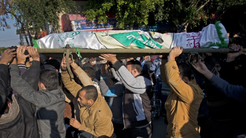 Palestinian mourners carry the body of Hamas militant Taysir Smeiri during his funeral Wednesday in the Gaza town of Khan Younis. He was killed during a clash with Israeli forces along the Gaza-Israel border.
