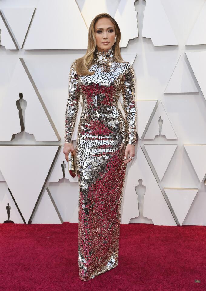HIT: Jennifer Lopez reflects the glamor of the Oscars in a gold-embroidered mirror mosaic gown by Tom Ford.