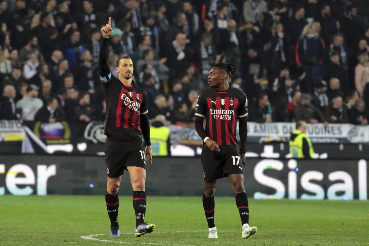 Milan's Zlatan Ibrahimovic, left, celebrates after scoring to 1-1 during the Serie A soccer match between Udinese Calcio and AC Milan at the Friuli stadium in Udine, Italy, Saturday March 18, 2023. (Andrea Bressanutti/LaPresse via AP)