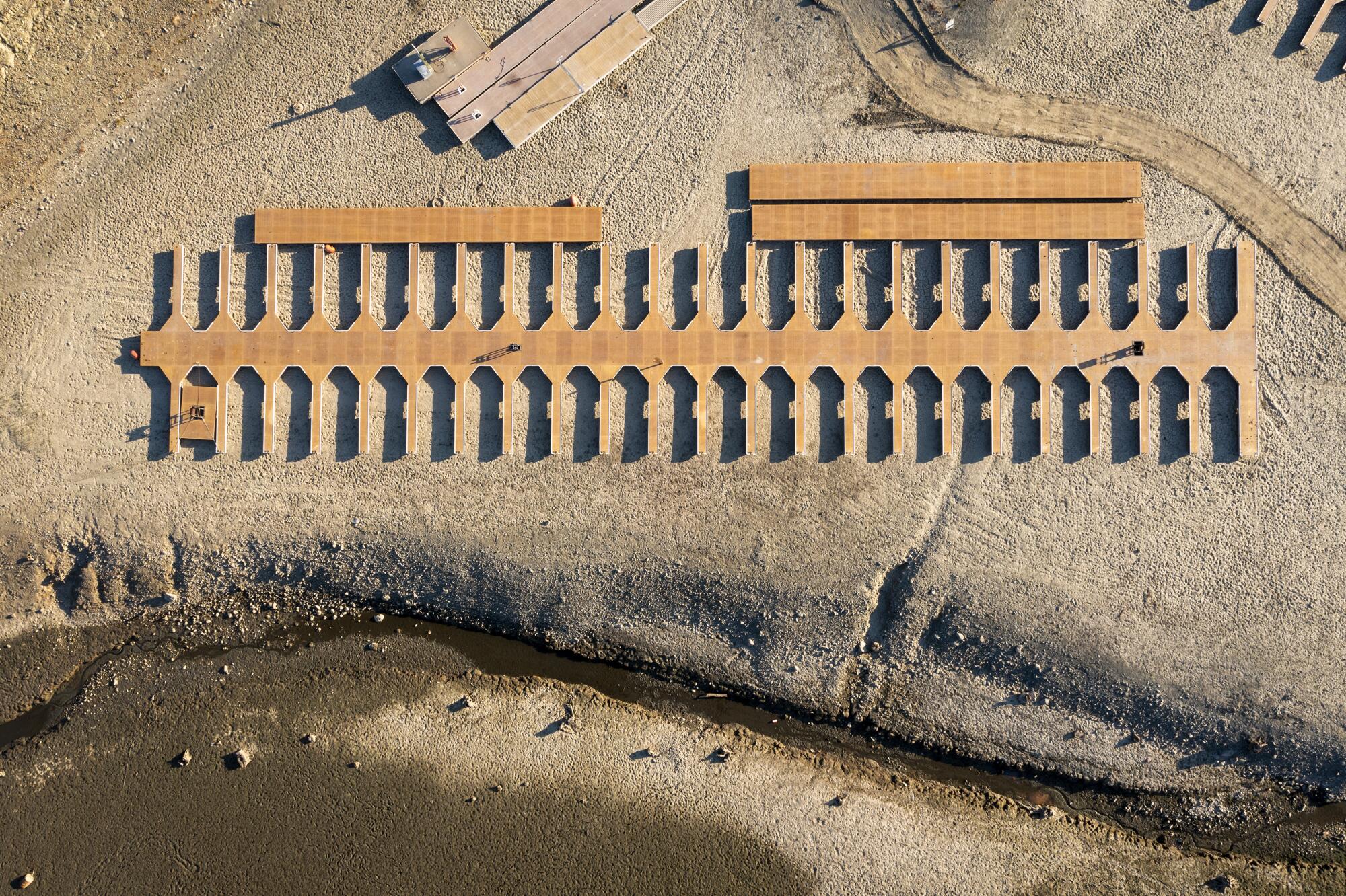 Boat slips lie stranded on dry land as water levels recede at Folsom Lake.