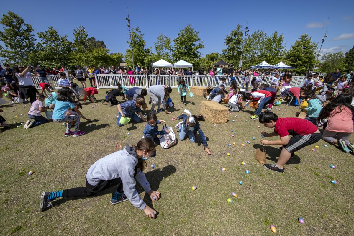 Kids scoop up plastic eggs at the "Egg Scramble."
