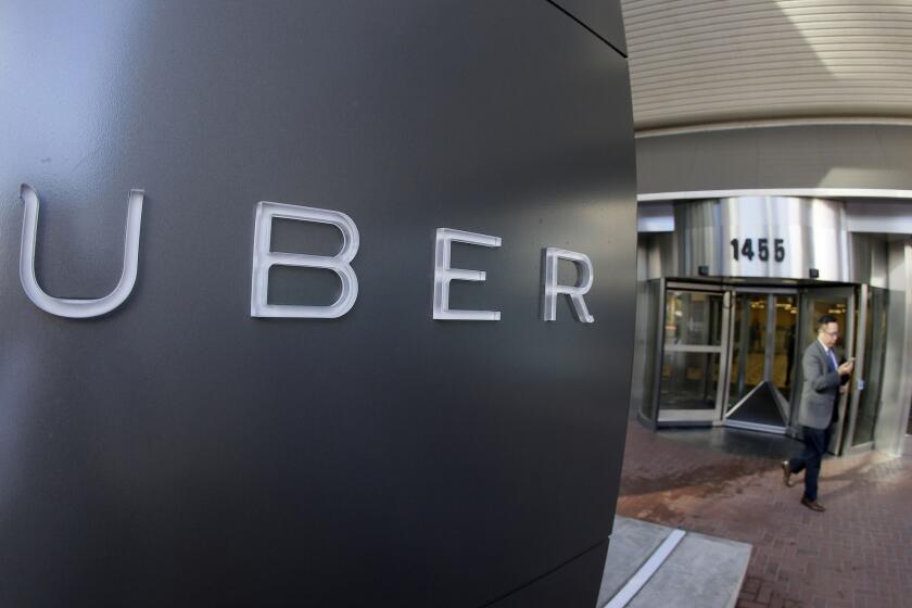 In this Dec. 16, 2014, file photo, a man leaves the headquarters of Uber in San Francisco.