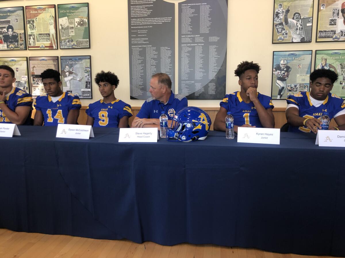 Bishop Amat players and coaches answer questions at media day.